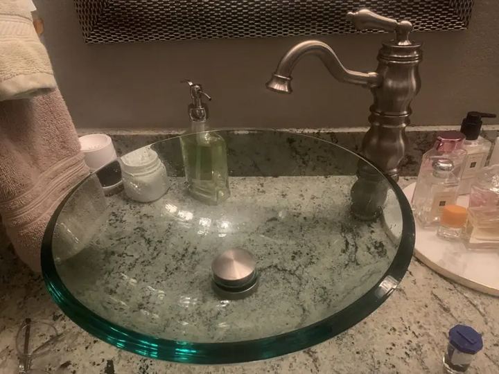 Bathroom faucet replaced over a glass vessel sink
