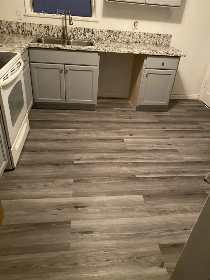 Gray vinyl plank flooring installed in a kitchen
