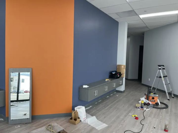Accent wall painted orange and blue in an office space