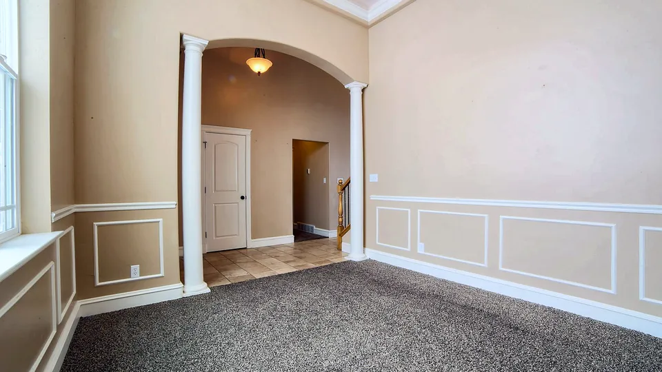 Room with white baseboard and wainscot trim
