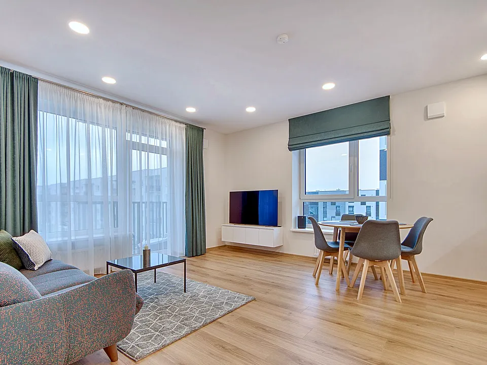 Living room with wide windows and sheer curtains