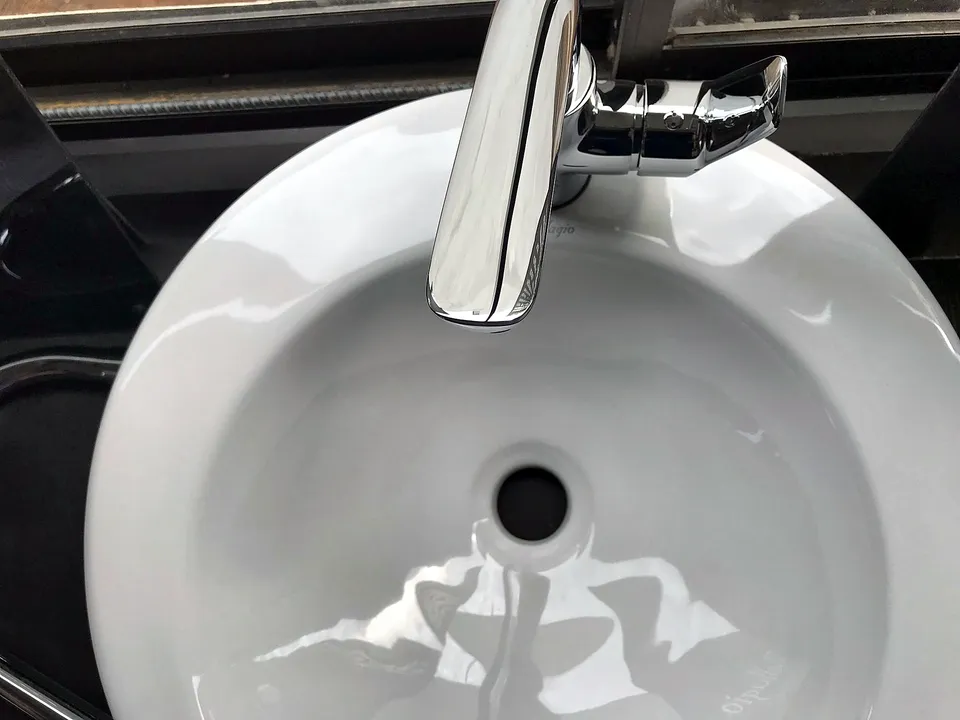 Close-up of a white sink basin and drain
