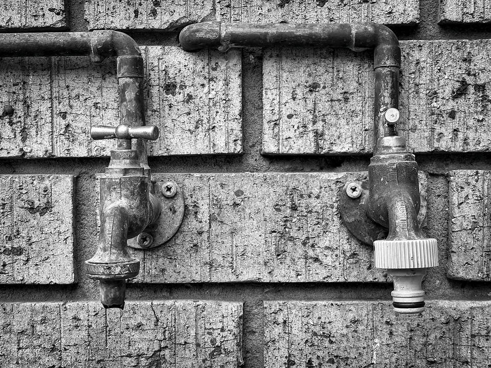 Pair of brass hose spigots on a block wall