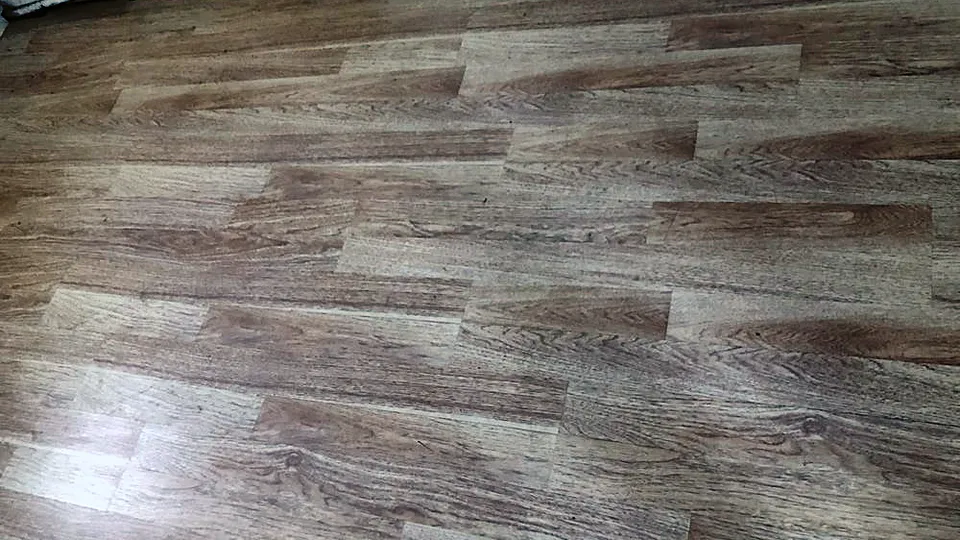 Room finished with new gray wood-look vinyl plank flooring