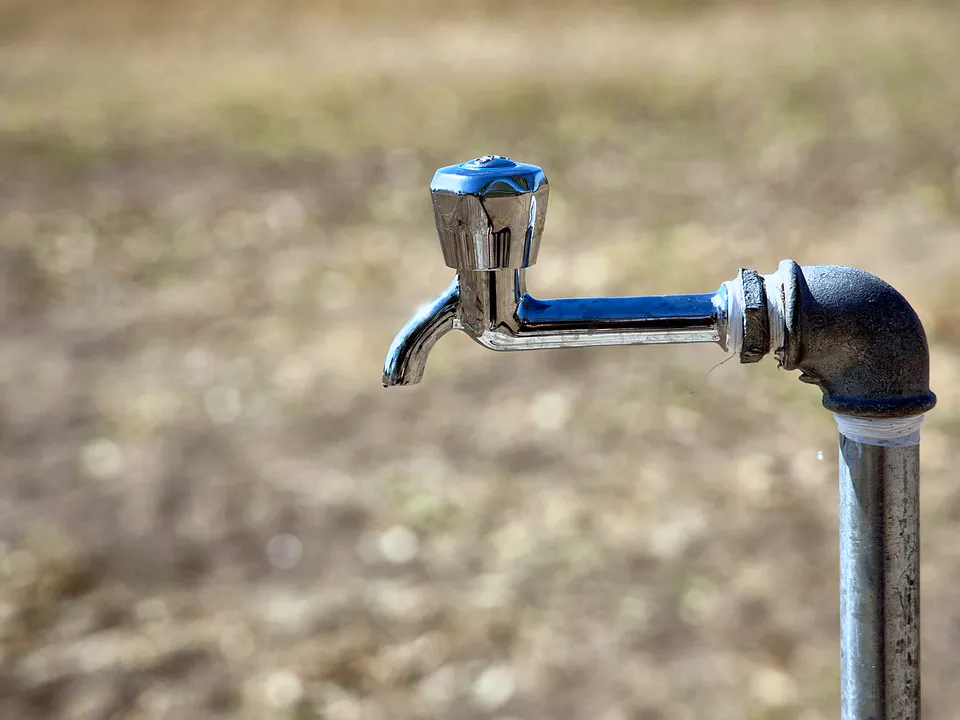Old outdoor water tap on a pipe