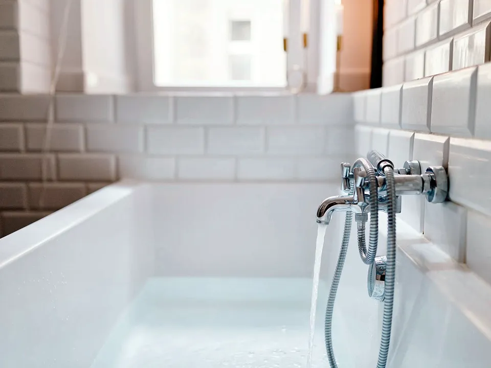 White tub along a tiled wall