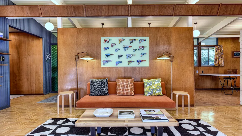 Mid-century living room with wood paneling and low furniture