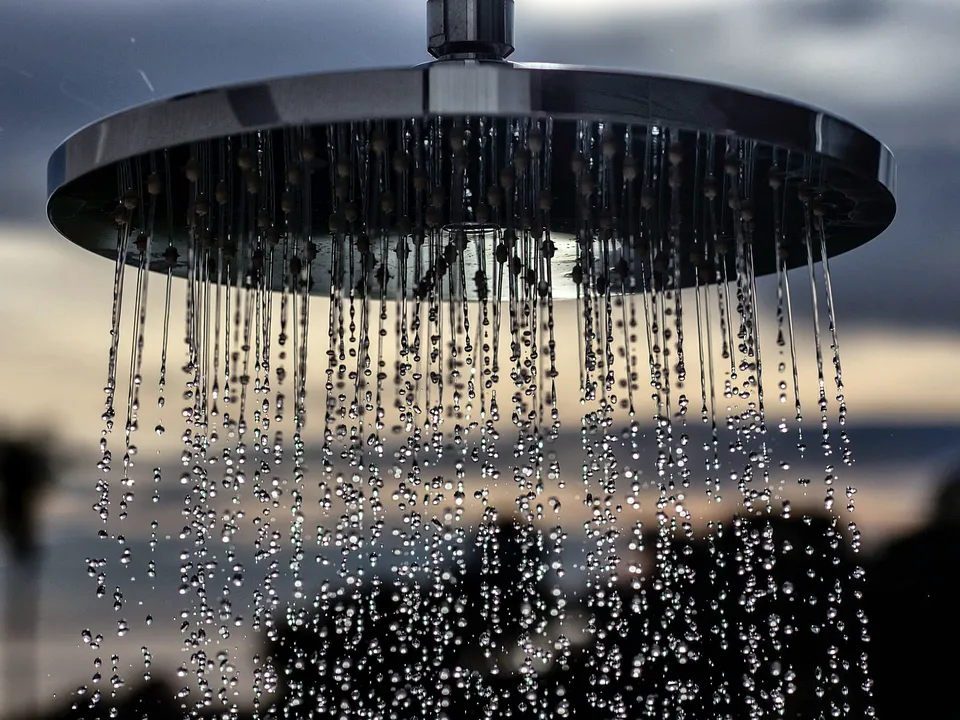 Round rain shower head spraying water