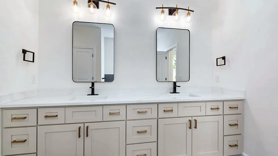 Double vanity with black sconce lights above two mirrors