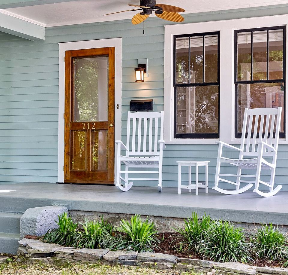 Front porch with a wall lantern beside a wood and glass door