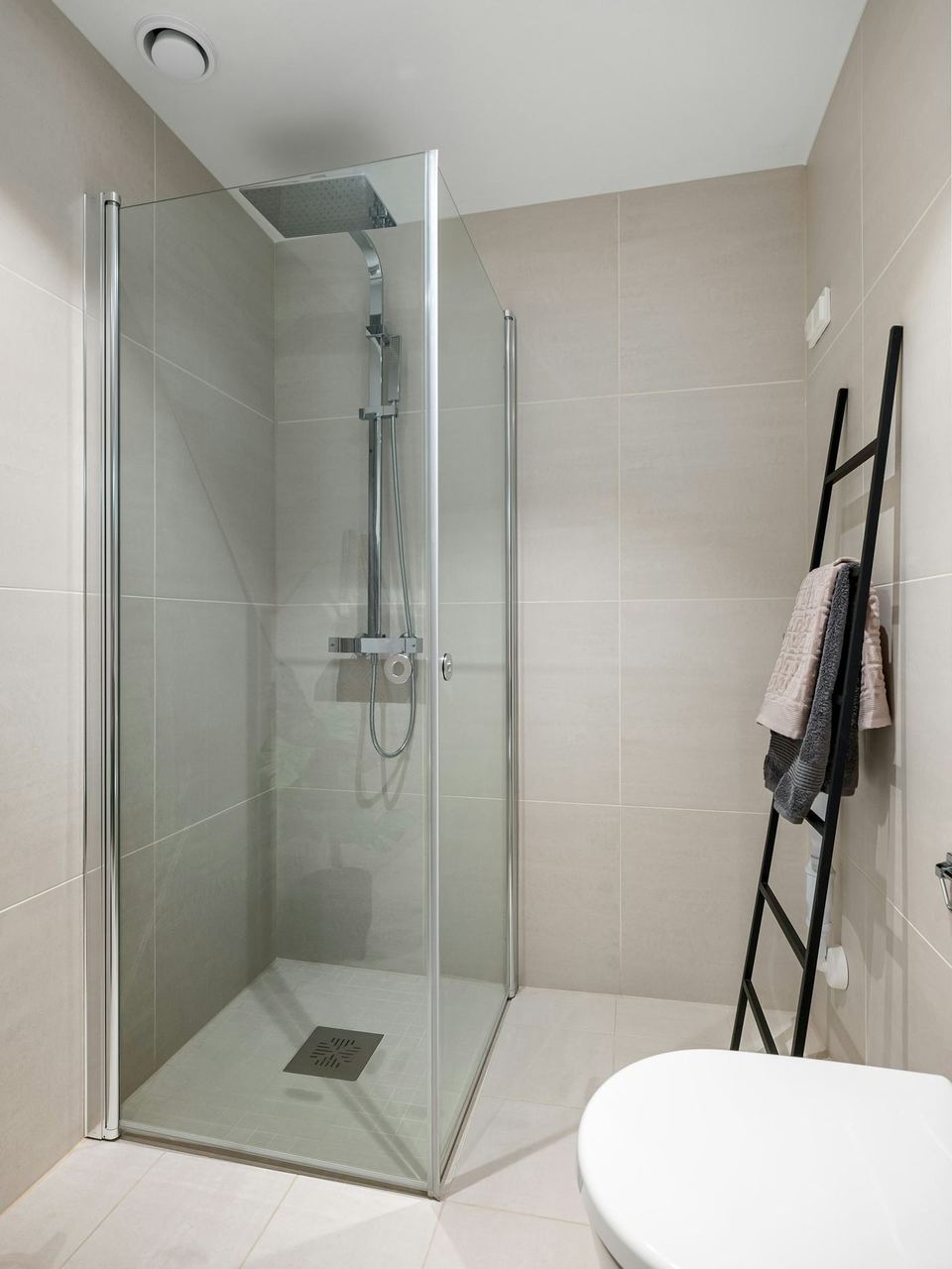 A tiled shower wall with fresh grout lines