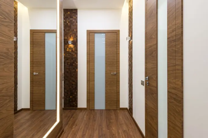 Hallway featuring wooden doors and design elements